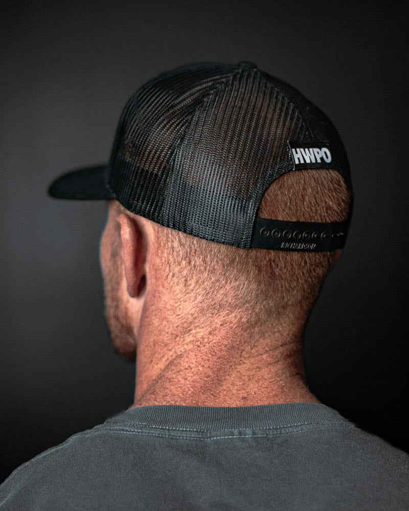 Rear view of Harry Palley wearing the HWPO Global Trucker Hat