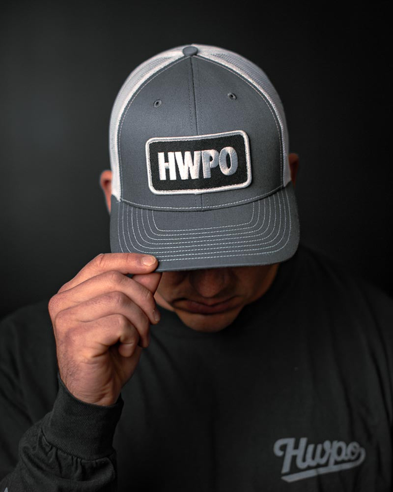 Josh Godinez showing the HWPO Trucker Hat in Grey