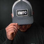 Josh Godinez showing the HWPO Trucker Hat in Grey
