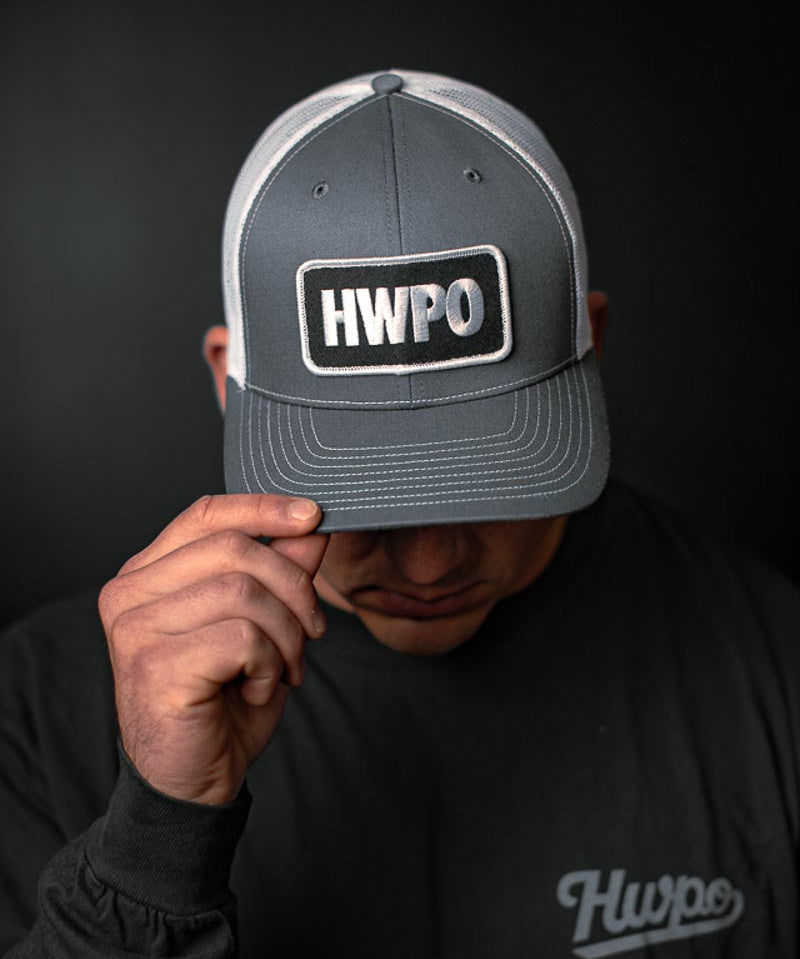 Josh Godinez showing the HWPO Trucker Hat in Grey