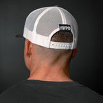 Rear view of HWPO Trucker Hat in Grey on Josh Godinez